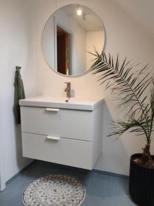 un bagno con un lavandino bianco e uno specchio di 2vær lejlighed - Dronninglund a Dronninglund