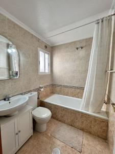 a bathroom with a tub and a toilet and a sink at House in Orihuela Costa La Zenia in Orihuela