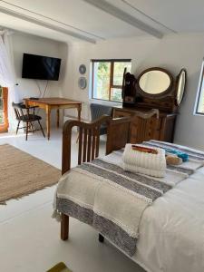a bedroom with a bed and a mirror and a table at Stay at Molly in Prince Albert