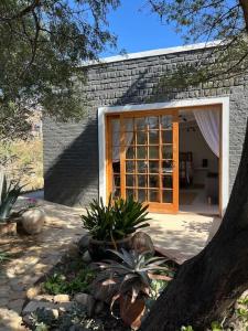 a house with a door open to a patio at Stay at Molly in Prince Albert