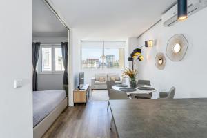 a white living room with a couch and a table at Angel Flats in Porto