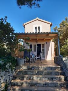 a house with a stone walkway to the front door at House ViEn in Nerezine