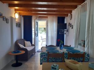 a living room with a table and a chair at House ViEn in Nerezine
