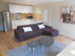 a living room with a couch and a kitchen at Saint Christophe in Omessa