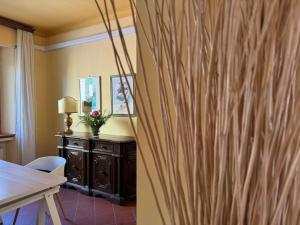 a room with a table and a wooden wall at Giardino Concordia Apartment in Lucca