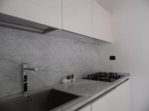 a kitchen with a sink and a stove at Around the Medieval Tower in Viterbo