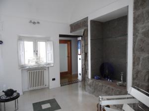 a living room with a stone wall and a window at Around the Medieval Tower in Viterbo +13 photos