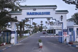 a sign for a marina on the side of a road at Royal sand Marina Smir in Marina Smir