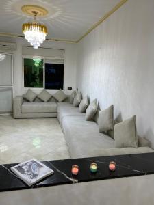 a living room with a large couch in a room at Royal sand Marina Smir in Marina Smir