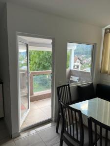 a dining room with a table and a sliding glass door at Vila Cri Cri in Buşteni