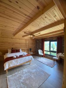 a bedroom with a bed and a wooden ceiling at Mira Suit Apart in Çamlıhemşin