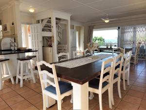 a kitchen and dining room with a table and chairs at Dolphin Place Southport in Port Shepstone