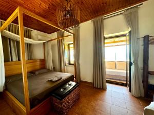 a bedroom with a bunk bed and a large window at Jasmine Stoupa in Stoupa