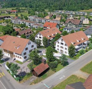 an aerial view of a residential neighborhood with houses at Visionary Hospitality Bassersdorf, Zürich - Premium Apartments in Swiss Style with Free Parking, Washer, Kitchen, Terrace, Vaulted Cellar Event Room, Bus Stop, 15' City & Airport in Bassersdorf