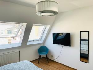 TV a/nebo společenská místnost v ubytování ROOFTOP RESlDENCE