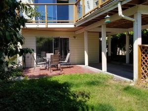 a patio with a table and chairs on a house at Bright 2 BR, Great Location in West Vancouver