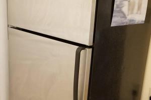 a black and white refrigerator with a picture on it at Bright 2 BR, Great Location in West Vancouver