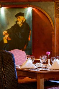 a table in a restaurant with a painting of a man at Killarney Avenue in Killarney