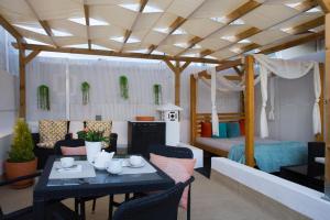 a room with a bed and a table and chairs at AMMO in Olhão