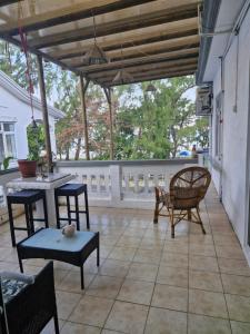 a patio with a table and chairs and a table and chairs at JN Sunflower in Le Morne
