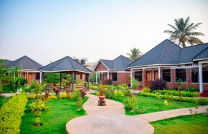 a house with a garden in front of it at Siafu Serenity Lodge in Mto wa Mbu