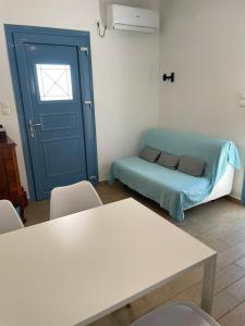 a room with a bed and a blue door at Theros house in Kythira