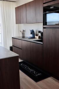 a kitchen with wooden cabinets and a counter top at Ghent Penthouse in Ghent