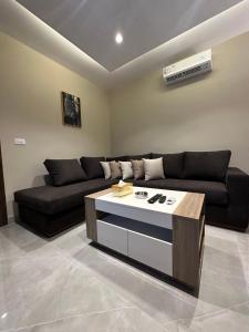 a living room with a couch and a coffee table at Chic Apartments For Rent ave2-4 in Amman
