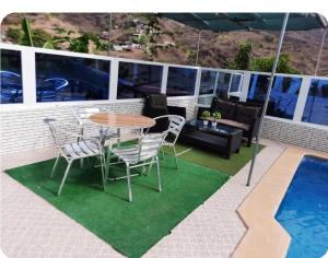 a patio with a table and chairs and a pool at Pensão Simão & Júlia in Órgãos +36 photos