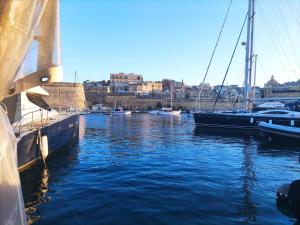 a group of boats are docked in a harbor at Charming Studio in Historic Kalkara Malta in Kalkara