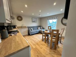 a kitchen and living room with a table and chairs at The Top Deck, Wells-next-the-Sea in Wells next the Sea +15 photos