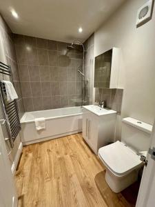 a bathroom with a toilet and a sink and a shower at The Top Deck, Wells-next-the-Sea in Wells next the Sea