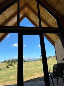 a view from the inside of a building with a window at Eternum Glamping in Žabljak