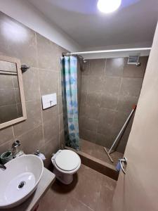 a bathroom with a toilet and a sink and a shower at Hospedaje LH primero D in La Unión