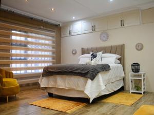 a bedroom with a large bed and a window at Thornville Guest house Platinum in Pietermaritzburg