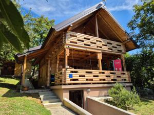 a house constructed of logs with stairs in a yard at Holiday home LUNA in Donje Orešje