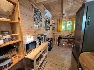 a kitchen and dining room in a tiny house at Holiday home LUNA in Donje Orešje