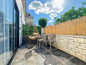 a patio with a table and chairs and a fence at Zace Studios in Ksamil