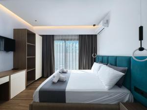 a bedroom with a large bed and a large window at Zace Studios in Ksamil