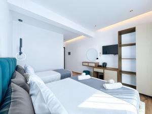 a room with two beds and a couch at Zace Studios in Ksamil