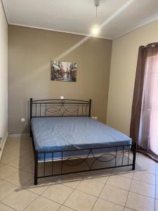a bedroom with a bed with a blue mattress at Peter appartments in Vrachati