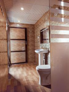 a bathroom with a toilet and a sink at Wadi Rum Majestic Camp in Wadi Rum