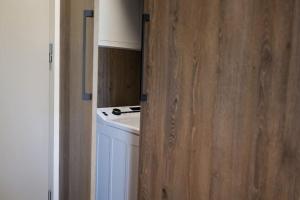 a kitchen with a white stove and a wooden wall at Aurora, Banská Bystrica in Banská Bystrica +8 photos