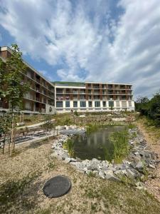 a building with a pond in front of a building at Aurora, Banská Bystrica in Banská Bystrica