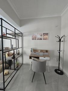 a room with a desk and a chair and a keyboard at Maggie's Blissful Escape in Loutraki
