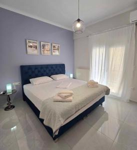 a bedroom with a large bed with towels on it at Maggie's Blissful Escape in Loutraki +24 photos