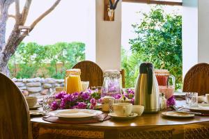 a wooden table with flowers on top of it at Corona Guest Farm in Corona