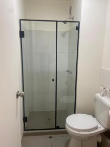 a glass shower in a bathroom with a toilet at Entire Apartment 20 min from airport - Cozy and Secure in Lima +4 photos