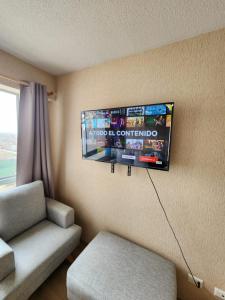 a room with a couch and a flat screen tv at Entire Apartment 20 min from airport - Cozy and Secure in Lima