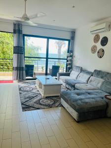 a living room with a couch and a table at Relax Oceanfront Suites in Sere Kunda